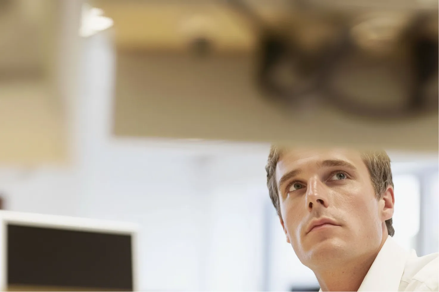 A young professional in an office with monitors